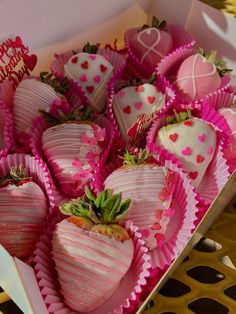 a box filled with chocolate covered strawberries on top of a table