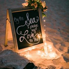 a chalkboard sign that says by the sea, i pledge my love to thee