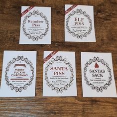 four santa's pass cards sitting on top of a wooden table