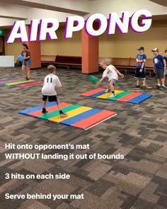 there are children playing on the floor with air pong mats in front of them