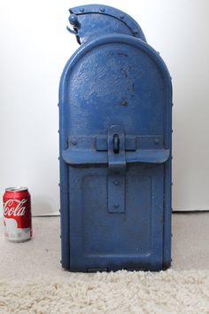 an old blue cooler sitting on the floor next to a can