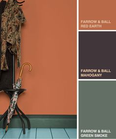 an orange and brown color scheme with clothes hanging on a coat rack next to a green and orange wall