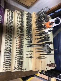 tools are lined up on a table in a workshop, ready to be worked on