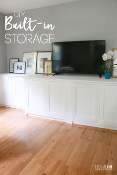 a tv sitting on top of a white entertainment center