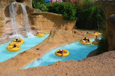 there are many people riding in rafts at the water park