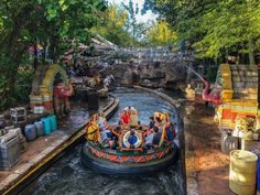 an amusement park filled with lots of people riding on top of a roller coaster ride