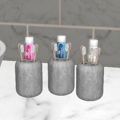 three toothbrush holders sitting on top of a marble counter