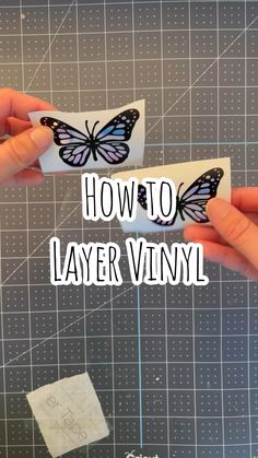 two hands are holding paper with the words how to layer vinyl