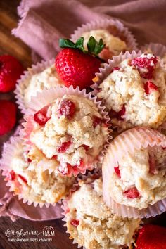 strawberries and muffins are sitting on a table