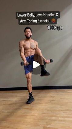 a man standing on top of a hard wood floor next to a wall holding a pair of dumbbells