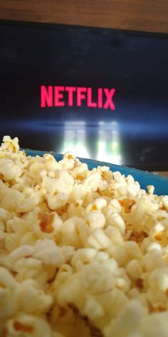 a bowl filled with popcorn sitting on top of a table