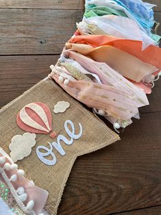 there are many different pieces of fabric on the table with it's name and hot air balloon