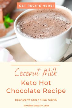 a close up of a cup of hot chocolate on a plate with text that reads coconut milk keto hot chocolate recipe