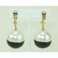 This is part of Chairish’s Costume Jewelry assortment.  What a great combination of a classic look with a youthful style!  These fun C.1980 clip on orb shaped earrings mix a faux pearl with a black enamel and then top it all off with sparkling rhinestones set in gold tone metal.  They are not hallmarked though they are well made and come from the estate of a fashionable lady with high end taste.  The look would pair well with Chanel or Karl Lagerfeld designs.  Of course they would also be a stylish way to dress up t-shirt and jeans.  Very good vintage condition.  Each earring measures 2.75" long x 1.25" wide. Round Pearl Drop Clip-on Earrings For Evening, Elegant Black Enamel Dangle Earrings, Luxury Black Enamel Fine Jewelry Earrings, Black Enamel Clip-on Earrings For Evening, Formal Gold Clip-on Earrings With Black Enamel, Luxury Black Enamel Clip-on Earrings For Evening, Diamond Dangle Earrings, T Shirt And Jeans, Diamond Drop Earrings