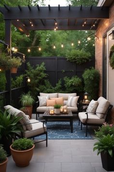 an outdoor living area with couches, tables and potted plants