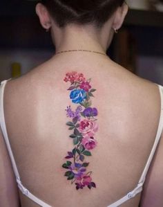 the back of a woman's neck with flowers on it