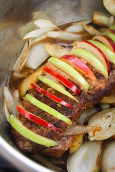 meat with apples and onions cooking in a pot