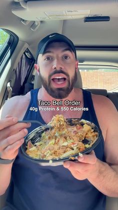 a man in the back seat of a car holding a plate of food and looking surprised