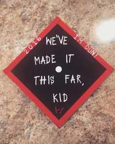 a graduation cap with writing on it that says, we've made it this far, kid