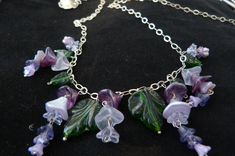 Spring breezes purple wisteria necklace, created with Czech pressed glass beads, long sterling silver chain and a sterling silver  adjustable flower clasp. Purple Czech Glass Dangle Jewelry, Nickel-free Purple Czech Glass Jewelry, Purple Wisteria, Leaves Necklace, Violet Flowers, Violet Flower, Bib Necklaces, Necklace Statement, Leaf Necklace