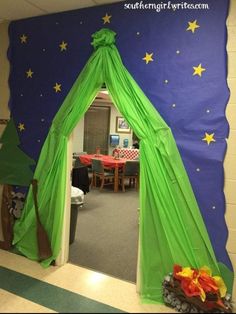 a room decorated in green and blue with stars on the ceiling, as well as a tent