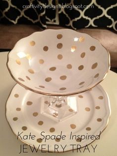 two plates stacked on top of each other with gold polka dot designs in the middle