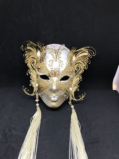 Venetian Mask for decoration - Traditional and original papier-mache Venetian mask, handmade and decorated with metal insert, gold-leaf and glitters,enriched with Swarovski crystals. Dimension::Hight 31cm,width 24cm Decoration only,not wereable All our masks are handmade papier-machè masks made in Venice. Our decorators use techniques typical of the Venetian tradition such as stucco, acrylics, gold and silver-leaf, macramè, passementerie, glitters and crequelè to offer you a wide range of origin Elegant Gold Mask For Masquerade, Elegant Gold Mardi Gras Masks, Gold Carnival Eye Mask, Gold Fantasy Mask For Costume Party, Elegant Gold Mask For Carnival, Gold Mask For Mardi Gras, Formal Gold Eye Mask, Gold Mardi Gras Masquerade Eye Mask, Elegant Gold Masks For Carnival