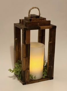 a wooden lantern with a lit candle inside