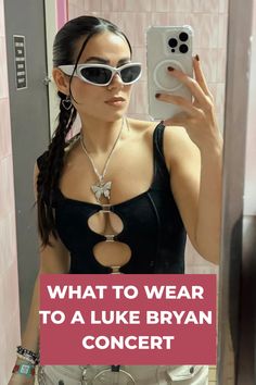 a woman taking a selfie in a mirror with the caption what to wear to a luke ryan concert