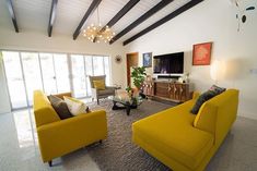 a living room filled with furniture and a flat screen tv