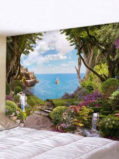 a bed room with a large wall mural on the wall and a view of the ocean