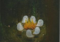 some white birds are standing around a fire