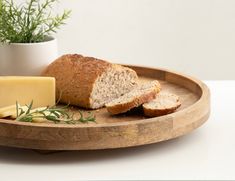 bread, cheese and herbs on a wooden tray