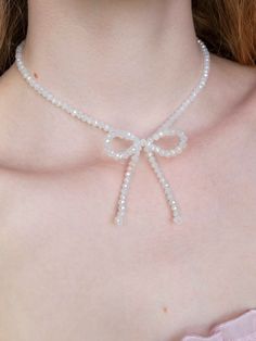 This sparkling, soft white beaded bow necklace is an intricately, handmade piece of jewelry that goes well with everything. They can easily be dressed up or down for casual and formal/going-out looks, making a great everyday necklace that is still eye-catching and unique. A great amount of care, passion, and attention to detail goes into every step of its creation, making it a truly high-quality and special piece of jewelry that you can feel good about wearing for years to come. This makes the perfect gift for her. OTHER COLORS HERE: https://www.etsy.com/shop/OliviaBeeken?section_id=42513357 Details -Made with medical grade stainless steel finishings so it will NEVER tarnish or cause skin irritation.  -Necklace length is 14.5 inches -There is a lobster claw and a 2-inch chain on the end so White Ribbon Jewelry For Party, White Butterfly Knot Jewelry For Wedding, White Necklace With Butterfly Knot For Gift, White Bow Tie Jewelry As Gift, White Bow Tie Jewelry For Gift, White Pearl Jewelry With Ribbon Detail, White Pearl Jewelry With Ribbon, White Ribbon Necklace For Parties, White Jewelry With Decorative Bow For Party