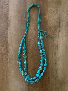 Turquoise stone beaded necklace. Handmade. Adjustable sweade tie closure. 17 inches at inner strand 18 inches at outter strand. Southwestern Multi-strand Adjustable Beaded Necklaces, Southwestern Multi-strand Beaded Necklaces, Adjustable Beaded Turquoise Lariat Necklace, Southwestern Multi-strand Beaded Necklace, Adjustable Beaded Lariat Turquoise Necklace, Hand-strung Turquoise Western Necklace, Hand-strung Western Turquoise Necklace, Western-style Hand-strung Turquoise Necklace, Adjustable Southwestern Turquoise Necklace Hand-strung