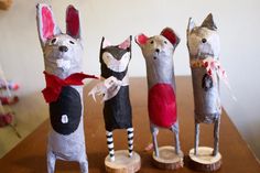 four paper mache mice are lined up in a row on top of a table