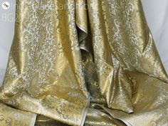 Grey Indian Brocade Fabric Yardage Banarasi Blended Silk Bridal Wedding Dresses Lehenga DIY Crafting Sewing Drapery Upholstery Costumes. This is a beautiful heavy banarasi art silk brocade floral design fabric in Grey and Gold. ➤Product: Brocade Fabric ➤Fabric Type: Blended Silk (Viscose and Silk) Fine quality Zari Brocade Weaving from Banaras ➤Color: Grey and Gold ➤Width: 44 inches. ➤Condition: New ➤Code: bg2290 ➤Listing for 1 Yard of fabric. ➤Care: Dry Clean Only You can use this fabric to mak Elegant Dupatta With Gold Embroidery For Traditional Ceremonies, Elegant Brocade Dupatta With Gold Embroidery, Wedding Brocade Dupatta With Gold Embroidery, Elegant Gold Fabric In Traditional Drape Style, Elegant Gold Fabric For Traditional Drapes, Gold Bollywood Fabric For Wedding, Fitted Gold Fabric For Wedding, Elegant Brocade Dupatta For Wedding, Gold Fitted Wedding Fabric