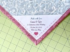 a close up of a pink and white wedding handkerchief