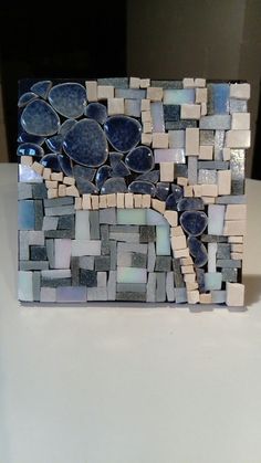 a mosaic tile sculpture with blue and white tiles