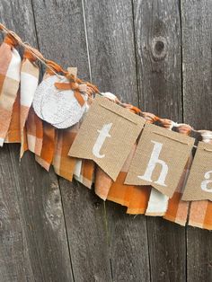 an orange and white burlap banner with the word happy on it