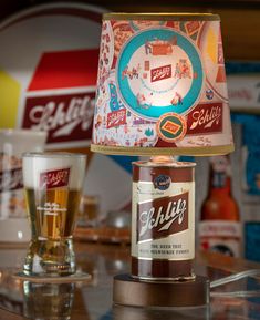 a lamp that is sitting on top of a table next to a beer bottle and glass