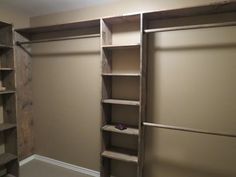 an empty walk in closet with shelves and shoes on the floor, next to a toilet