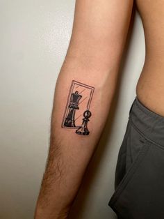 a man's arm with a tattoo on it and an image of a chess piece