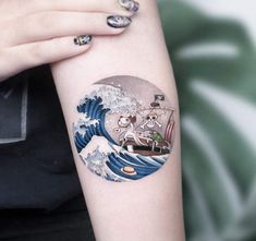 a woman's arm with a tattoo on it and an image of a boat in the ocean