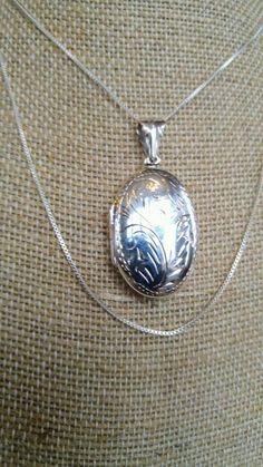 "A lovely sterling silver locket, hand-engraved; this sweet locket appears delicate but is sturdily made and truly beautiful. I've added a delicate but reliable box chain A few images show the sweet addition of a real cultured pearl suspended on a sterling silver wire. I can add that bit if whimsy, too, if you'd like. Note: As you compare lockets for purchase, insist on sterling silver. Sellers who advertise \"antique silver\" or just \"silver\" are not offering you real sterling, but rather a s Sterling Silver Locket, Silver Locket, Silver Coat, Silver Lockets, Downton Abbey, Box Chain, Hand Engraving, The Sweet, Silver Wire