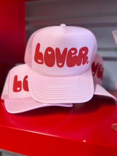 Declare your love in style with our Lover Puff Vinyl Trucker Hat. This playful and eye-catching hat, featuring a unique lover puff design, will add a touch of fun to any outfit. Pink Trucker Hat LOVER in Red Puff across front Heart Detail adjustable back Puff Vinyl, Puff Design, Pink Trucker Hat, Outfit Pink, Store Hours, In Style, Trucker Hat, Vinyl, Hats