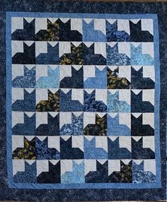 a blue and white quilt with stars on it