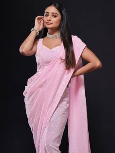 Look at this amazing Bollywood-style glowing baby pink georgette saree made with fully sequined work. This enchanting baby pink sequin saree comes with a matching georgette blouse also designed with fully sequined work. The saree is 5.50 meters long, while the blouse material is 0.80 meters.
Charming, rich, elegant, and flowy, this georgette saree is perfect for parties, engagements, or any special occasion. The baby pink color itself is sufficient to create a style statement, so you can go mini Pink Sequin Saree, Pink Georgette Saree, Party Wear Sarees Online, Baby Pink Color, Sequin Saree, Silk Saree Kanchipuram, Chanderi Silk Saree, Indian Saree Blouse, Simple Sarees