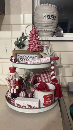 three tiered trays with christmas decorations on them