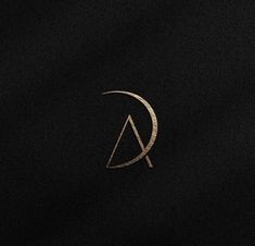 a black and gold logo with the letter a in it's center, on a dark background